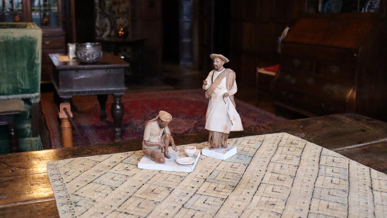 Two clay figures depicting Indian labourers